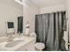Well-lit bathroom with a white vanity, modern fixtures, and shower with a decorative curtain at 4135 Pistachio Nut Ave, Las Vegas, NV 89115