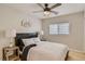 Bright bedroom features a ceiling fan, side tables with lamps, and natural light from the window at 4135 Pistachio Nut Ave, Las Vegas, NV 89115