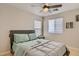 Comfortable bedroom featuring a ceiling fan, wood floors, and a neutral color scheme at 4135 Pistachio Nut Ave, Las Vegas, NV 89115