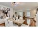 Dining area with modern chandelier, stylish dining table and neutral decor, creating an inviting atmosphere at 4135 Pistachio Nut Ave, Las Vegas, NV 89115