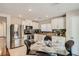 Bright eat-in kitchen featuring stainless steel appliances, granite countertops, and neutral cabinets providing style at 4135 Pistachio Nut Ave, Las Vegas, NV 89115