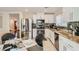 Bright kitchen with stainless steel appliances, ample cabinet space, and an open layout to the dining area at 4135 Pistachio Nut Ave, Las Vegas, NV 89115