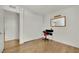 Bedroom with minimalist decor, small desk area, closet space, and hardwood flooring at 4237 Brockton Green Ct, Las Vegas, NV 89110