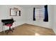 Bedroom with simple desk and chair, natural light from window, and hardwood flooring at 4237 Brockton Green Ct, Las Vegas, NV 89110