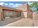 Exterior view of home highlighting the front patio, textured facade, and mature trees at 4237 Brockton Green Ct, Las Vegas, NV 89110