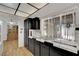 Practical kitchen features black cabinetry, white tiled accents, and seamless access to the living spaces at 4237 Brockton Green Ct, Las Vegas, NV 89110