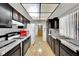 Well-lit kitchen features black cabinets, white tile, modern appliances, and hardwood flooring at 4237 Brockton Green Ct, Las Vegas, NV 89110