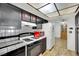 Functional kitchen with black cabinets, tiled countertops, and a bright red microwave at 4237 Brockton Green Ct, Las Vegas, NV 89110