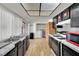 Efficient kitchen boasts black cabinets, white backsplash, and convenient access to the laundry area at 4237 Brockton Green Ct, Las Vegas, NV 89110