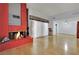 Bright living room featuring hardwood floors, a cozy fireplace, and an American Flag at 4237 Brockton Green Ct, Las Vegas, NV 89110