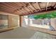 Private patio with exposed rafter beams, stucco walls, concrete floors and exterior sliding glass door at 4237 Brockton Green Ct, Las Vegas, NV 89110