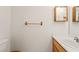 Cozy half-bathroom with a single sink vanity, wooden accents, and a neutral color scheme at 5025 Starfinder Ave, Las Vegas, NV 89108