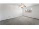 Neutral bedroom featuring carpet, ceiling fan and a large window with blinds at 5025 Starfinder Ave, Las Vegas, NV 89108