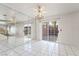 The large room features tile flooring, mirrored wall, and sliding glass doors to the backyard at 5025 Starfinder Ave, Las Vegas, NV 89108