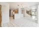 Open concept dining area with tile floors, staircase, kitchen, and a large mirrored wall at 5025 Starfinder Ave, Las Vegas, NV 89108