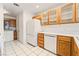 Bright kitchen features white appliances, light wood cabinets, and tile flooring at 5025 Starfinder Ave, Las Vegas, NV 89108