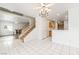 Open-concept floorplan featuring tile floors, staircase, a chandelier, and kitchen access at 5025 Starfinder Ave, Las Vegas, NV 89108