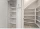 Walk-in pantry with white shelving, providing ample storage space for kitchen supplies and household items at 5025 Starfinder Ave, Las Vegas, NV 89108