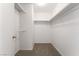 Walk-in closet featuring white walls, carpet and built in shelving at 5025 Starfinder Ave, Las Vegas, NV 89108