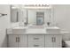 Bathroom features dual sinks, modern fixtures and a white vanity at 5241 Caspian Springs Dr # 103, Las Vegas, NV 89120
