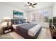 Staged bedroom with a ceiling fan, a picture window and neutral decor at 5241 Caspian Springs Dr # 103, Las Vegas, NV 89120