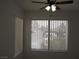 Well-lit room with vertical blinds, offering a view of the parking area and trees at 5241 Caspian Springs Dr # 103, Las Vegas, NV 89120