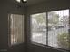 Bright room with large windows and a view of the parking lot and trees at 5241 Caspian Springs Dr # 103, Las Vegas, NV 89120