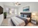 Bedroom features a large window with a ceiling fan and curated artwork at 5241 Caspian Springs Dr # 103, Las Vegas, NV 89120