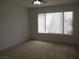 Bright bedroom featuring neutral carpet and a large window for natural light at 5241 Caspian Springs Dr # 103, Las Vegas, NV 89120