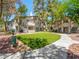 Exterior view of the condo complex with a well manicured lawn and mature trees at 5241 Caspian Springs Dr # 103, Las Vegas, NV 89120