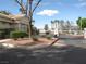 Gated community entrance with lush landscaping and mature trees at 5241 Caspian Springs Dr # 103, Las Vegas, NV 89120