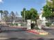 Gated community entrance with palm trees and desert landscaping on a sunny day at 5241 Caspian Springs Dr # 103, Las Vegas, NV 89120
