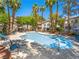 Resort-style pool area with lounge chairs, palm trees, and umbrellas at 5241 Caspian Springs Dr # 103, Las Vegas, NV 89120