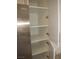 Spacious pantry provides ample storage next to stainless steel refrigerator at 5241 Caspian Springs Dr # 103, Las Vegas, NV 89120