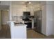 Updated kitchen with stainless steel appliances, light countertops, and ample storage space at 5241 Caspian Springs Dr # 103, Las Vegas, NV 89120