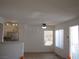 Open-concept living area with neutral tones and tile flooring, adjacent to a modern kitchen at 5241 Caspian Springs Dr # 103, Las Vegas, NV 89120
