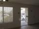 This living room has a window, door, security door and tiled floor at 5241 Caspian Springs Dr # 103, Las Vegas, NV 89120