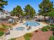 Community pool and hot tub with lounge chairs provides relaxation near garden landscaping at 5241 Caspian Springs Dr # 103, Las Vegas, NV 89120