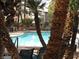A serene pool is surrounded by lush palm trees and comfortable lounge chairs at 5241 Caspian Springs Dr # 103, Las Vegas, NV 89120