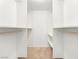 Walk-in closet with wooden hanging rods, shelving and neutral carpet at 5241 Caspian Springs Dr # 103, Las Vegas, NV 89120