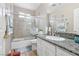 A full bathroom with a shower-tub combo, granite counters, and tile flooring at 5286 Monterey Park Cir, Las Vegas, NV 89146