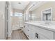 Bathroom with dual sinks, white cabinets and shower-over-tub at 5286 Monterey Park Cir, Las Vegas, NV 89146