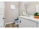 A stylish half bathroom with new vanity, modern fixtures, and a decorative mirror at 5286 Monterey Park Cir, Las Vegas, NV 89146