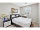A cozy bedroom with a TV, comfortable bed, and a window for natural light at 5286 Monterey Park Cir, Las Vegas, NV 89146