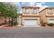 Two-story home with a terracotta roof, two-car garage, neutral stucco, and drought-resistant landscaping at 5286 Monterey Park Cir, Las Vegas, NV 89146