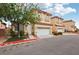 Residential street featuring townhomes with neutral exteriors, terracotta roofs, and two-car garages at 5286 Monterey Park Cir, Las Vegas, NV 89146
