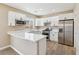 Well-lit kitchen featuring white cabinets, stainless steel appliances, and elegant marble-style countertops at 5286 Monterey Park Cir, Las Vegas, NV 89146