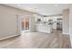 Bright, open-concept living area with a kitchen, dining area, and sliding glass doors at 5286 Monterey Park Cir, Las Vegas, NV 89146