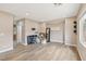 Unfurnished, light-filled living area with neutral walls and modern vinyl plank flooring at 5286 Monterey Park Cir, Las Vegas, NV 89146