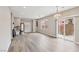 Bright, empty living area with vinyl flooring and sliding glass doors to the backyard at 5286 Monterey Park Cir, Las Vegas, NV 89146